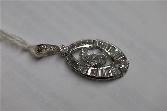 A platinum or white gold, pear, baguette and round cut diamond set elliptical shaped pendant,